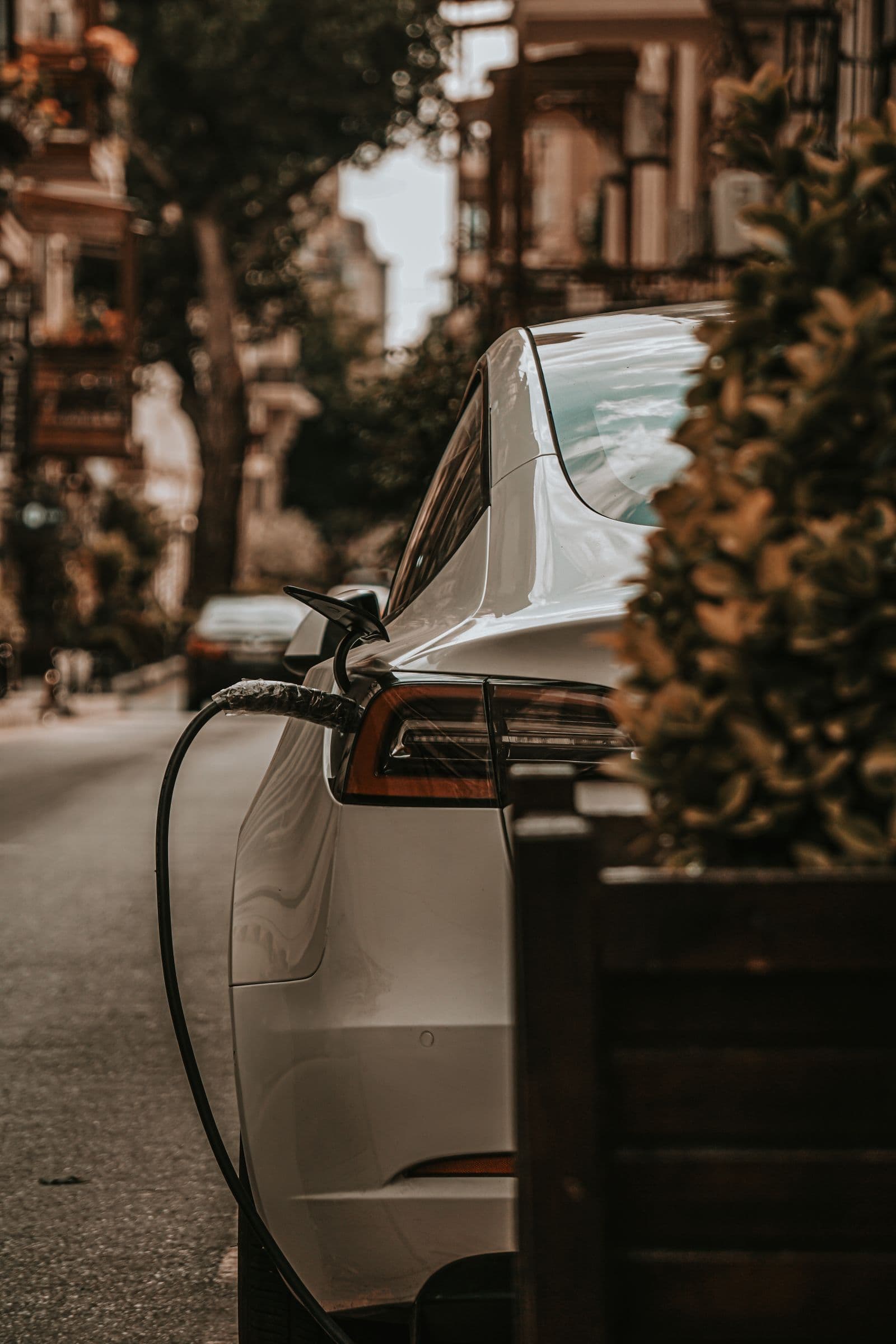 EV charger cable plugged into an electric car at home