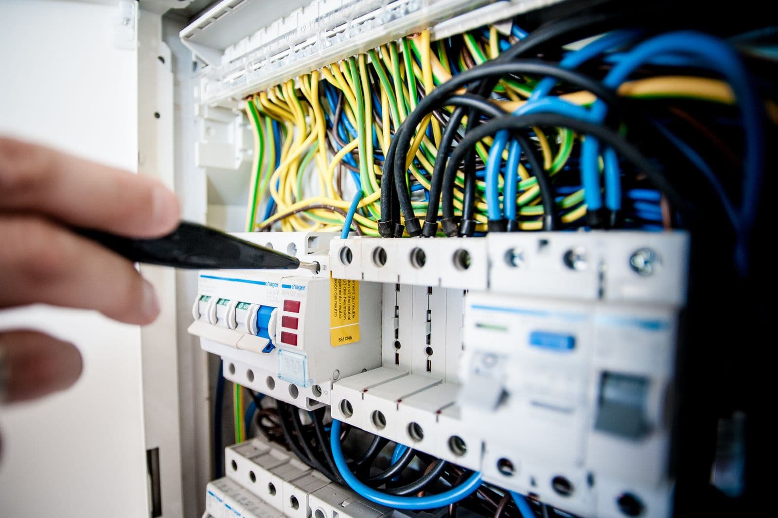 Technician testing wires with a multimeter
