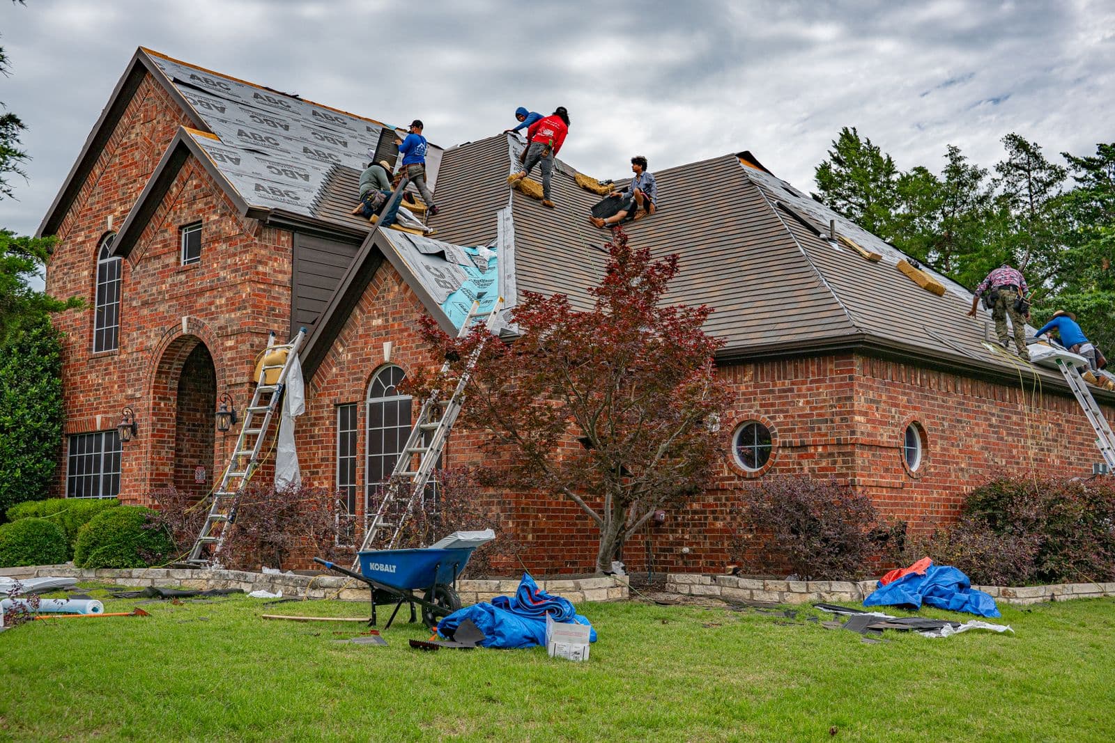 ZeroDown Roofing crew inspecting and working on a residential shingle roof