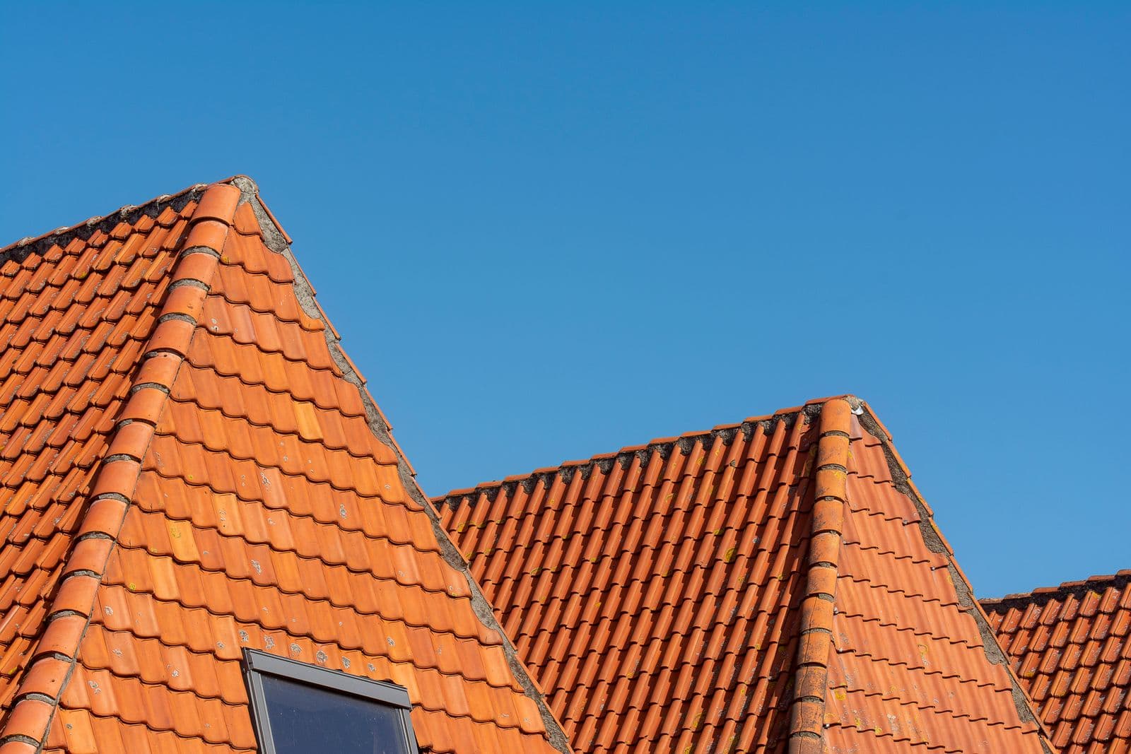 Clay tile roof against a clear sky