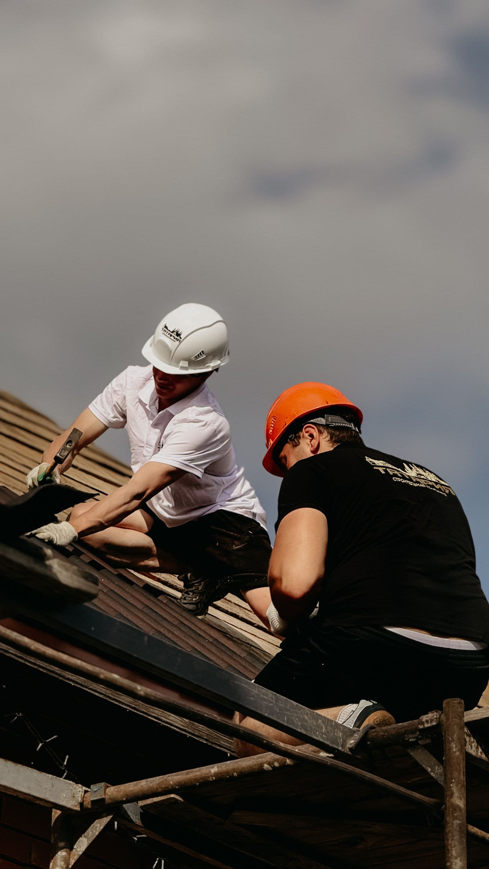 Two ZeroDown roofers working together on a residential roof