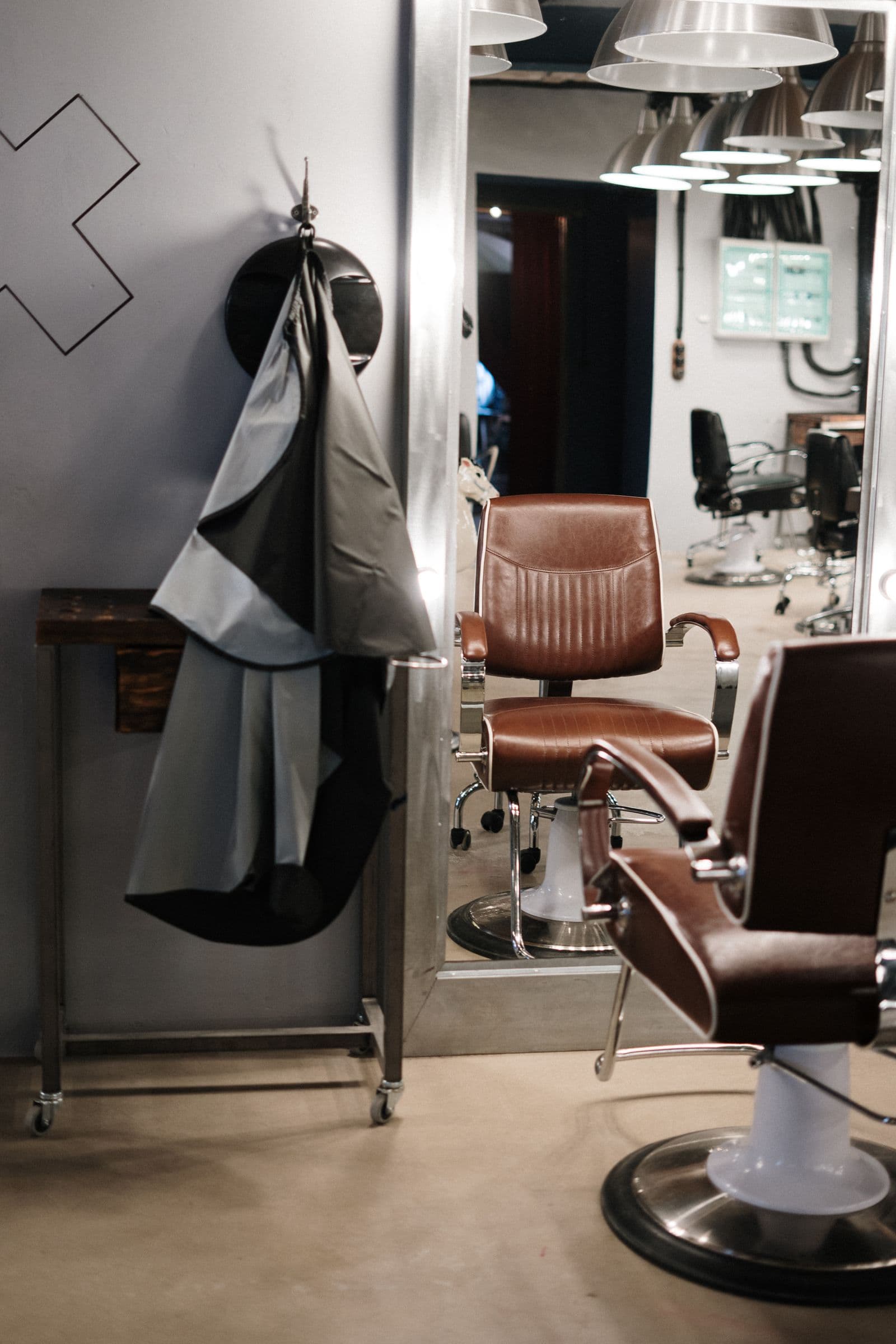 Inside Coastline Barber Club — easy light, worn wood and waiting chairs