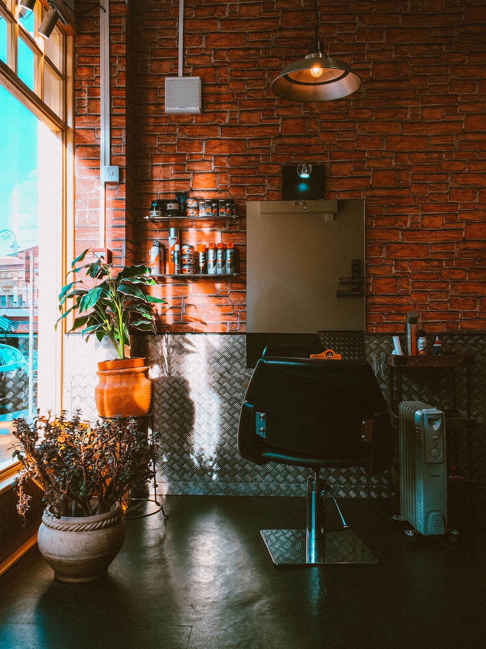Inside Midnight Fade after dark — chairs and mirrors under low neon light