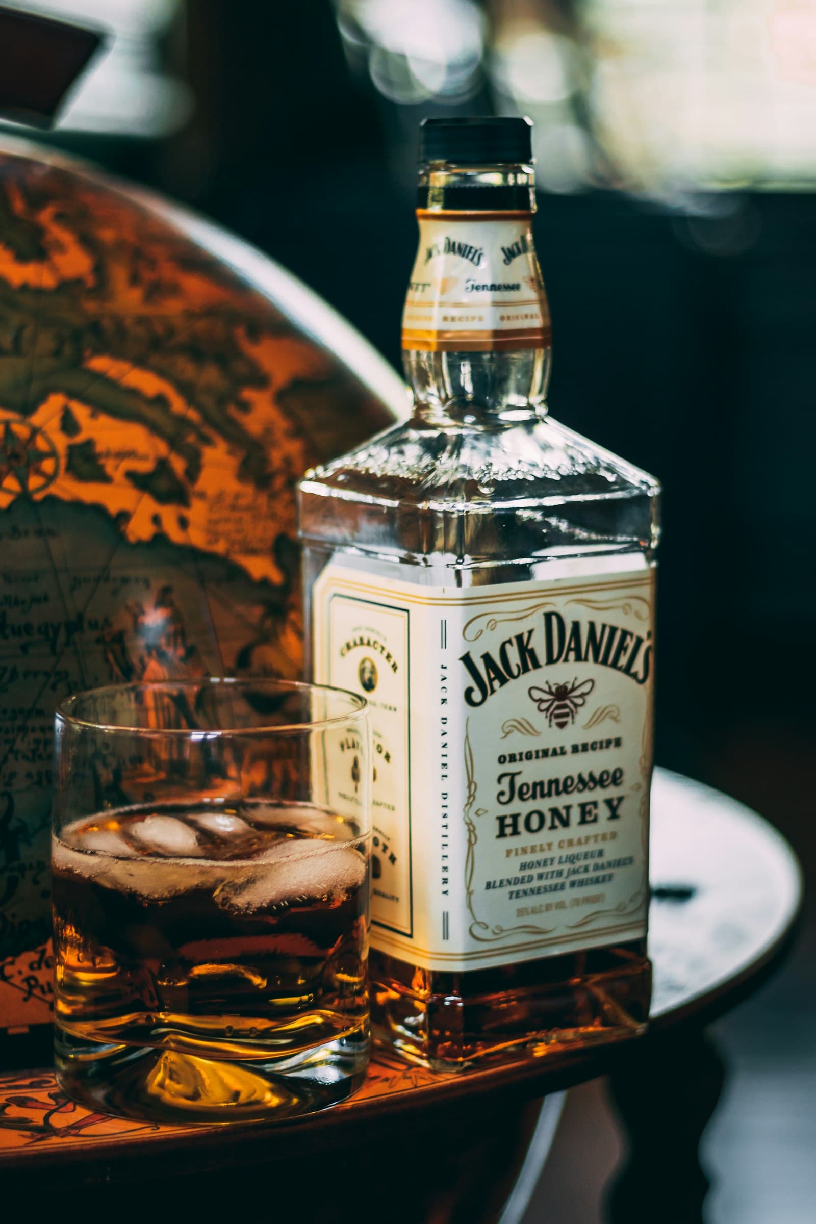 Whiskey glowing amber in a glass, low light