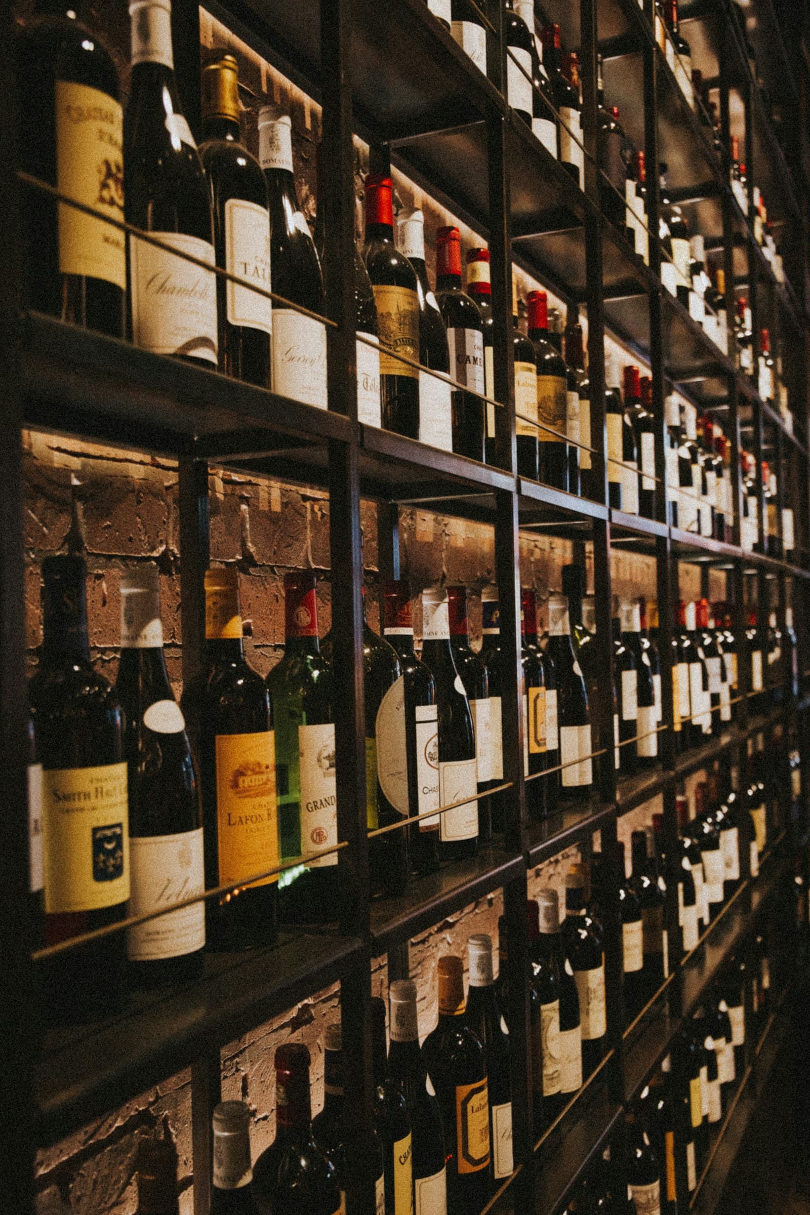 Wooden racks of wine bottles inside the Vine & Vessel shop