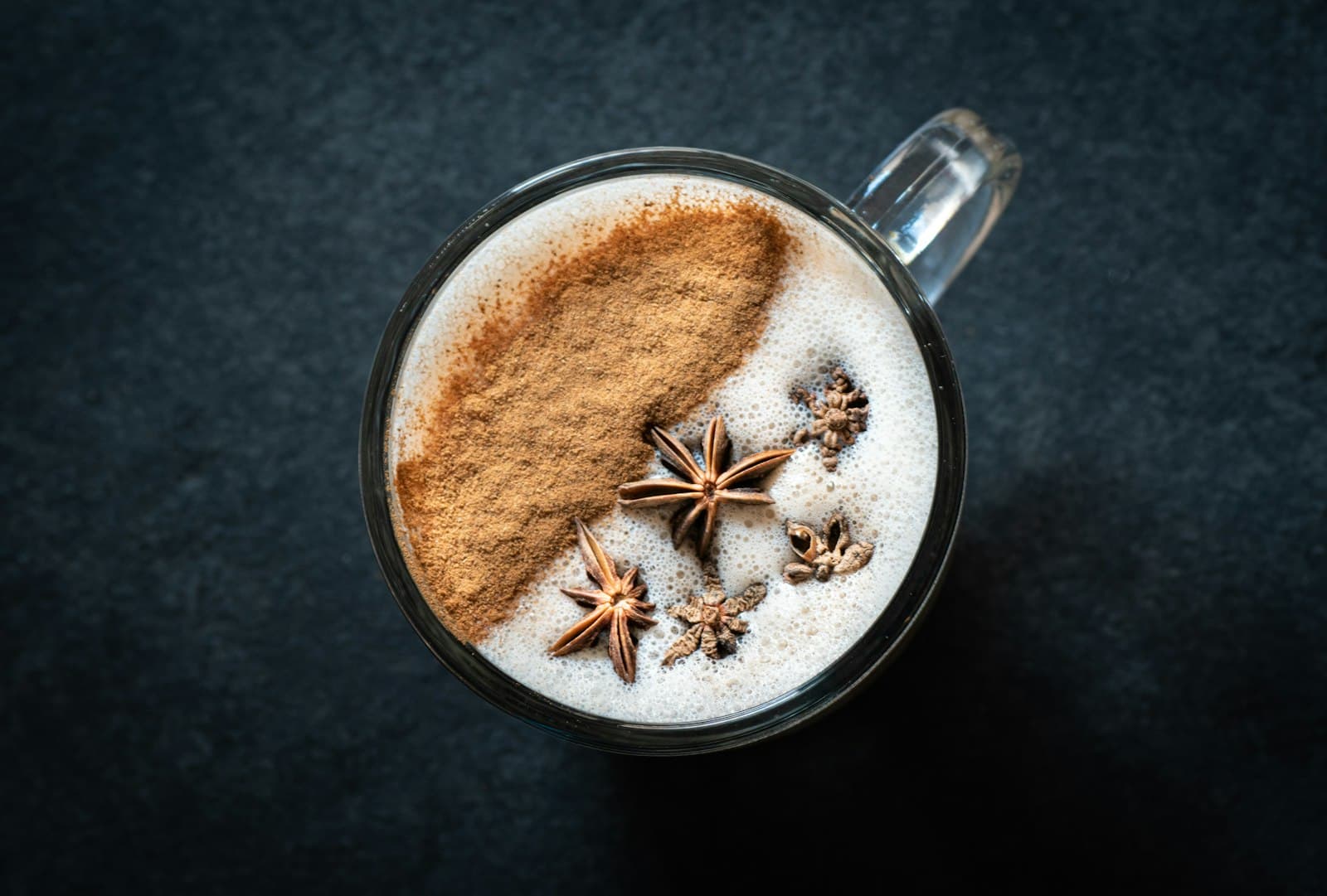 Cup of spiced masala chai with cardamom pods