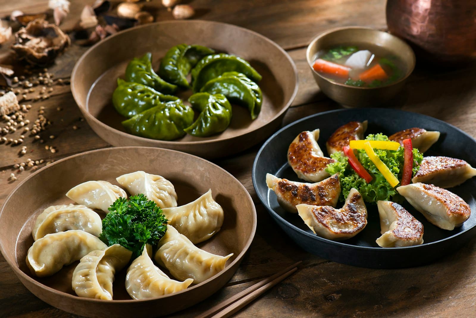 Bamboo steamer of hand-folded momos at a live station