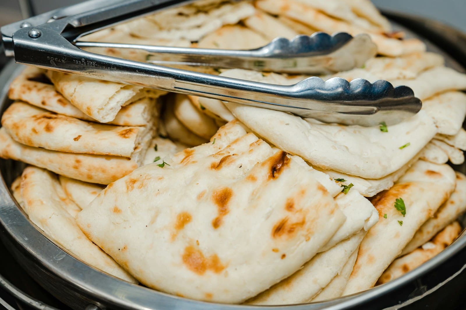 Blistered naan brushed with garlic butter