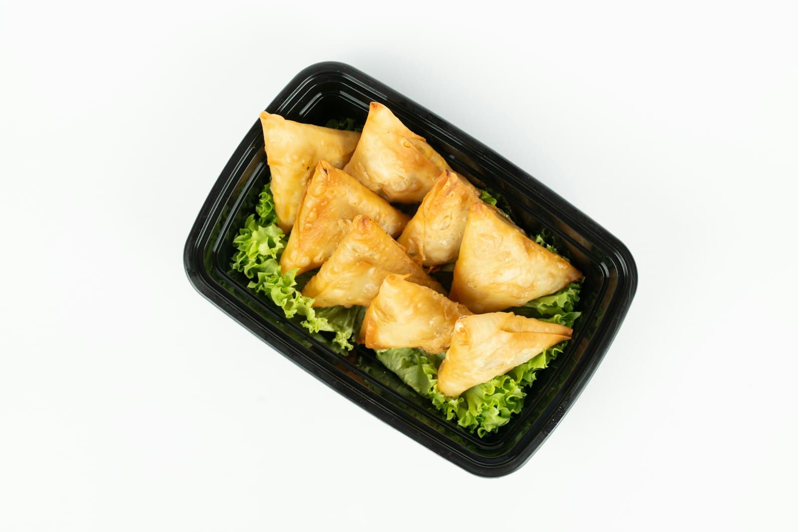 Golden samosas with tamarind and mint chutneys
