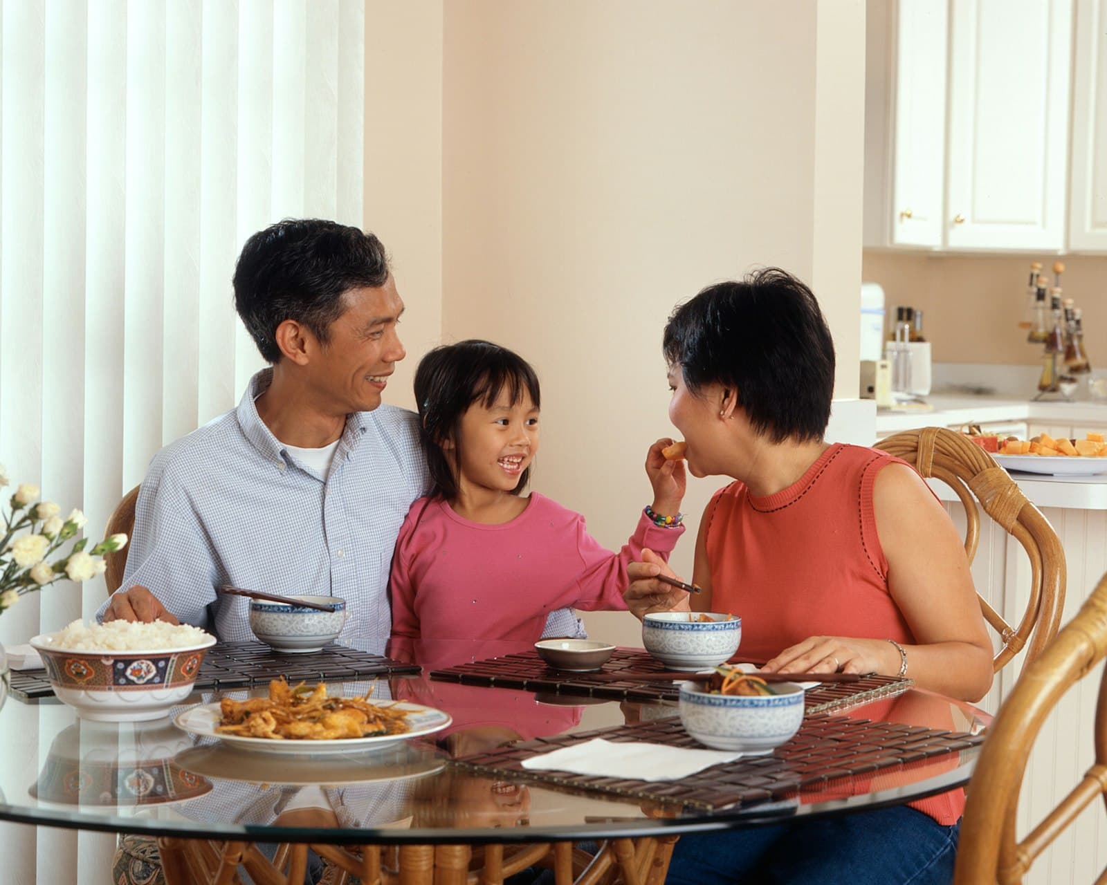 A family sharing dinner at a long table