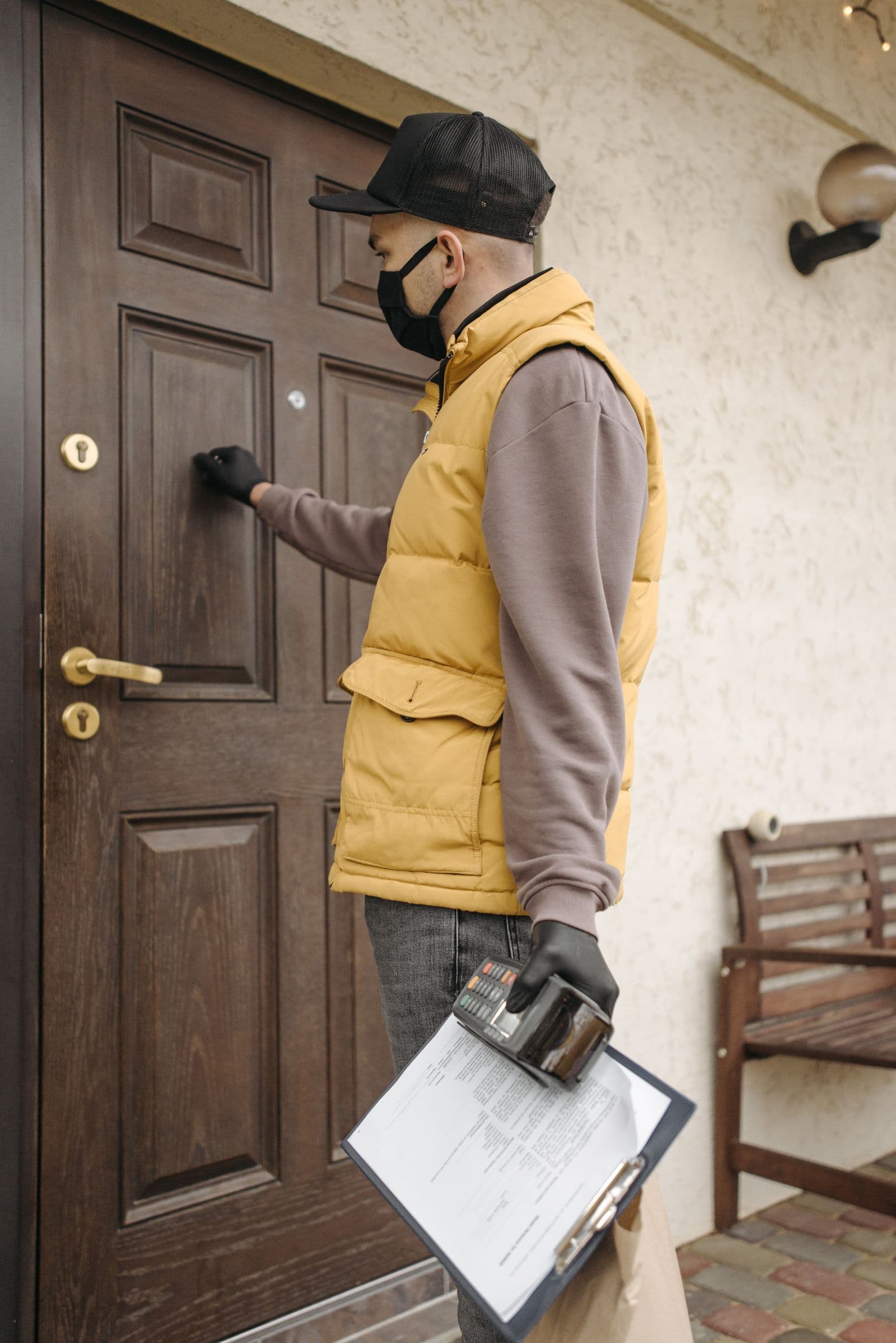 A friendly Halvorsen & Sons technician greeting a homeowner at the front door