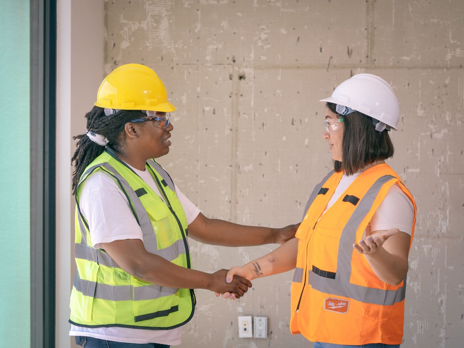 Two Halvorsen & Sons technicians shaking hands with a satisfied homeowner