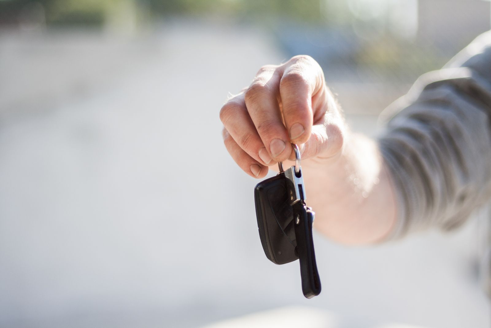 A set of car keys handed over the counter at Bluebonnet Auto