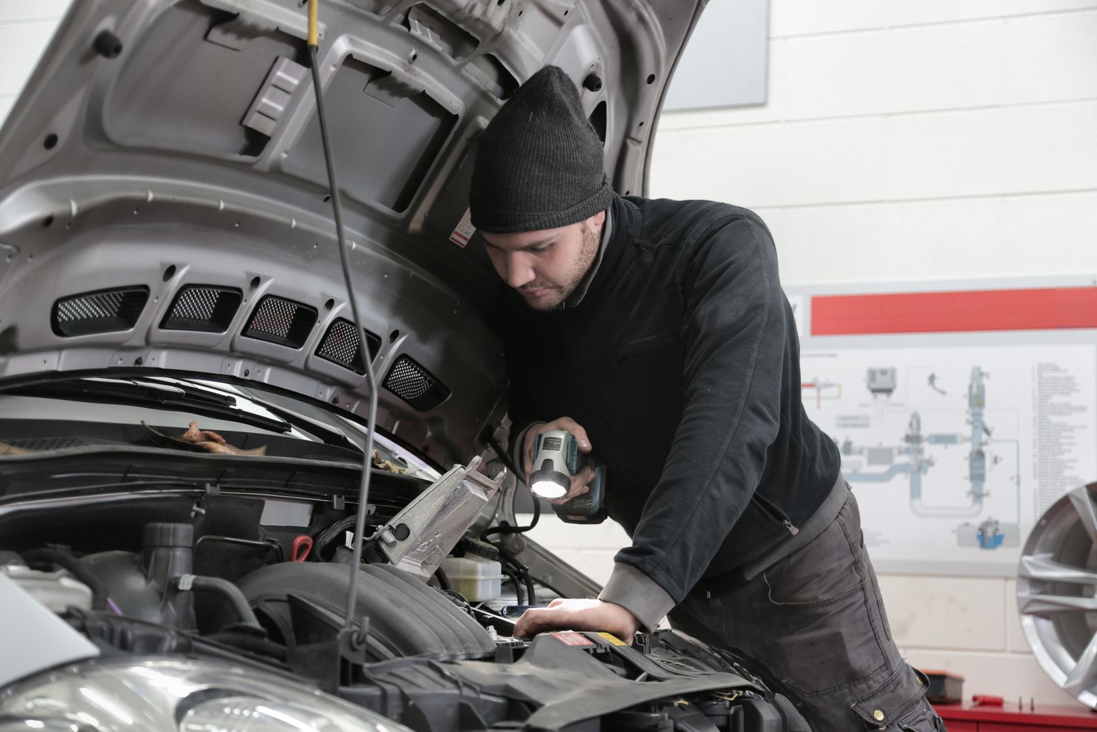Pat Malone, third-generation owner, working under a lift at Malone & Sons