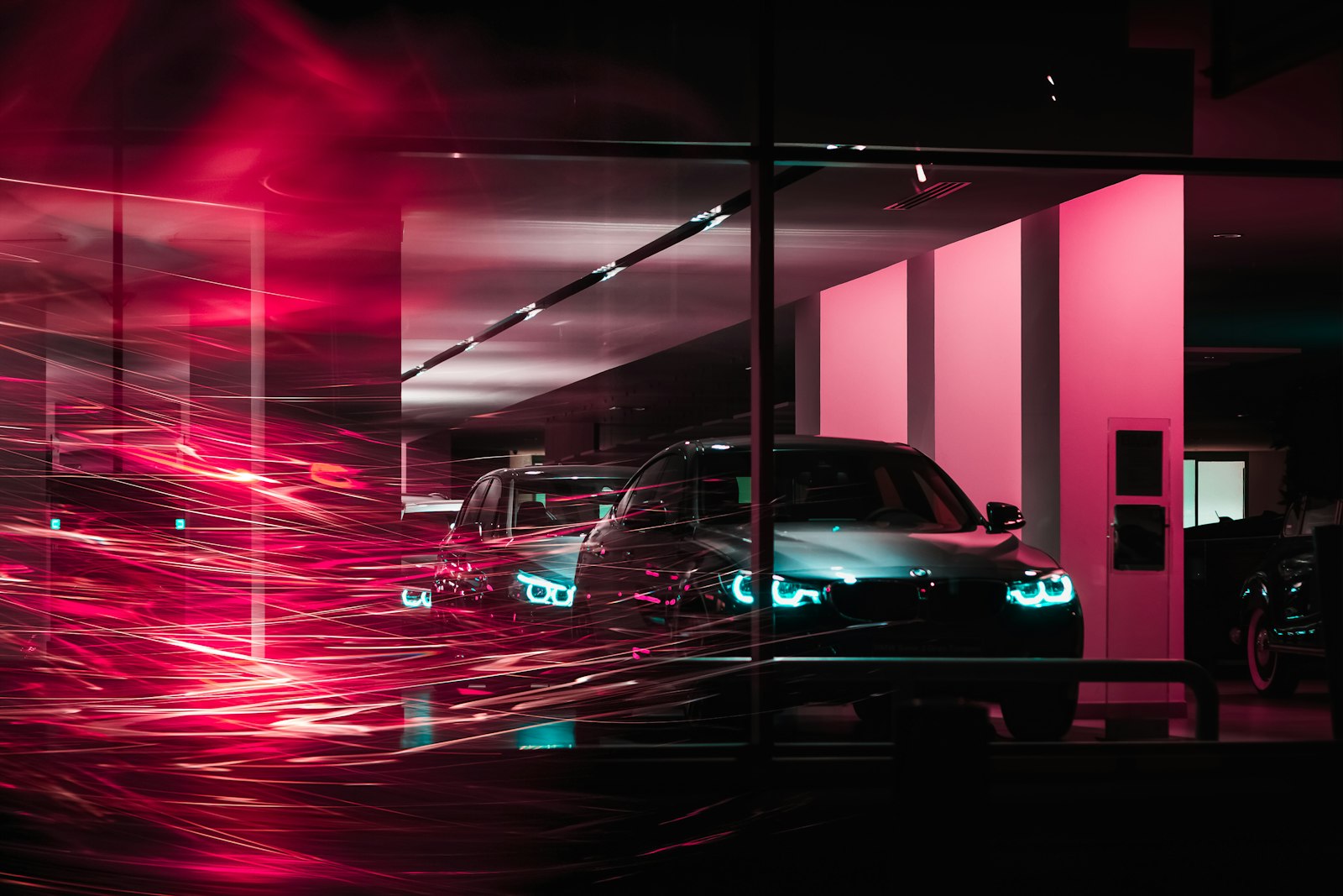 Werkhaus service bays glowing at night behind glass