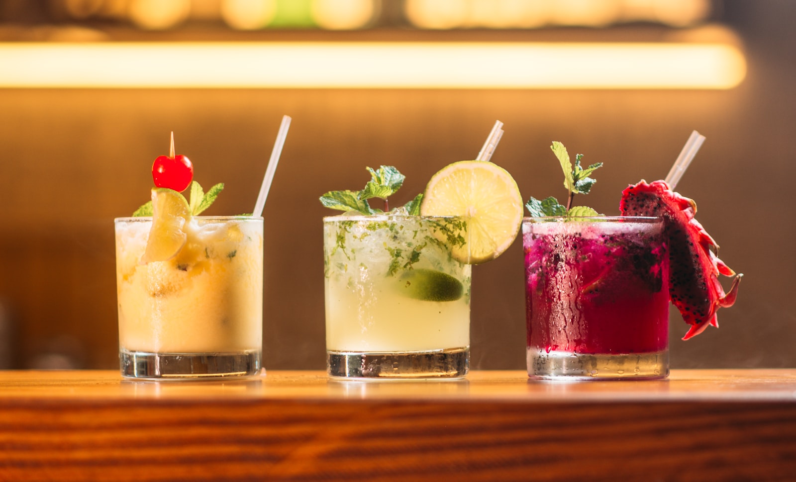 Bright cocktails lined up on a bar