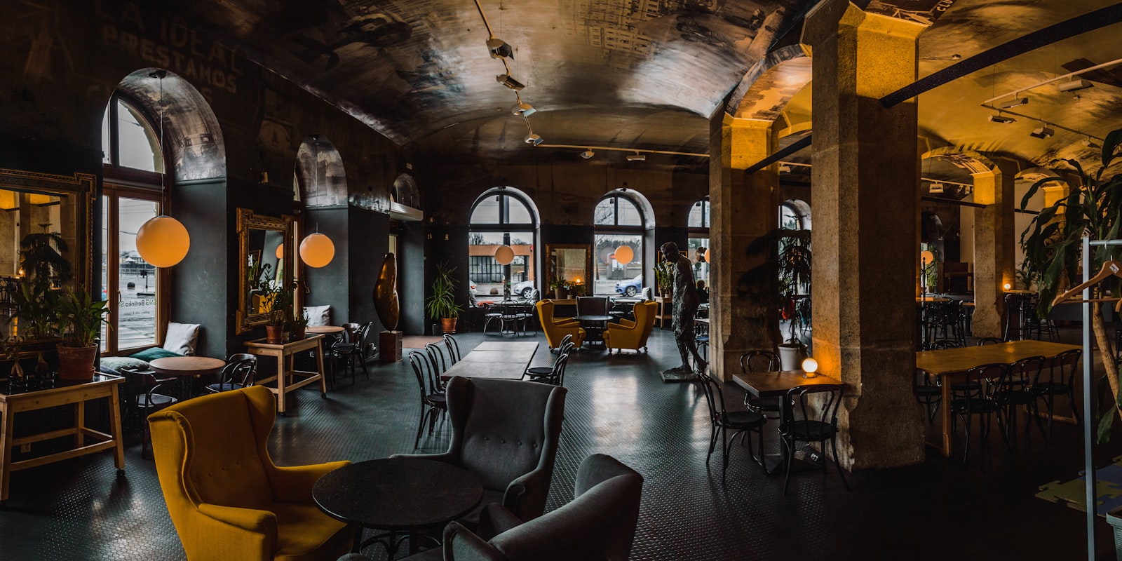 Inside Chiya House — warm lamplight, worn wood tables and steam over glasses of chiya